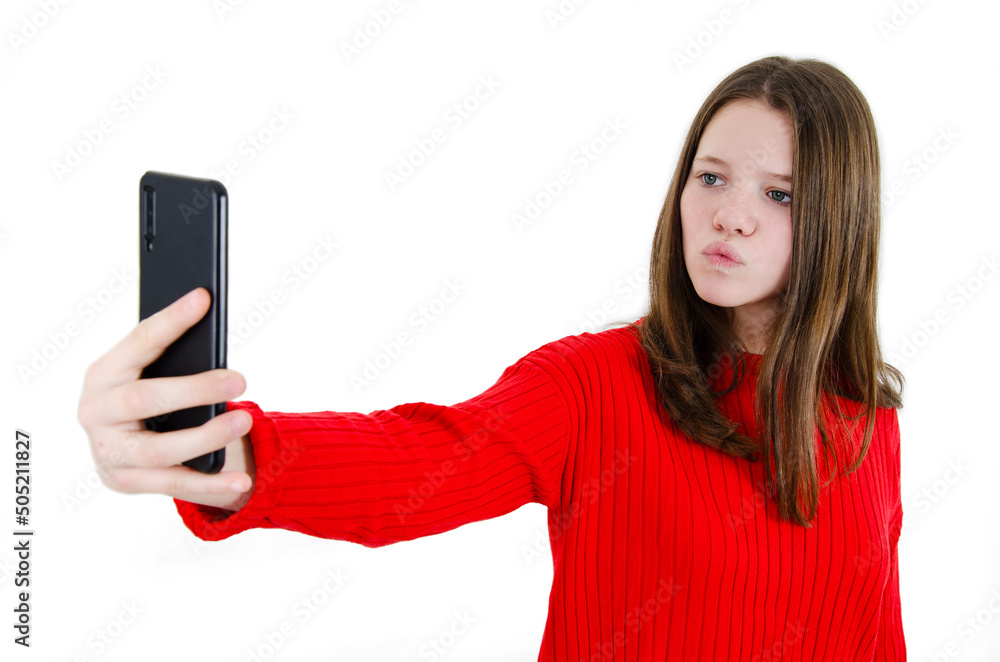 Smiling young girl making selfie photo on smartphone. Closeup portrait of beautiful teenage girl making selfie photo on smartphone. Isolated on white background. Close up portrait. Smiling young girl making selfie photo on smartphone. Closeup portrait of beautiful teenage girl making selfie photo on smartphone. Isolated on white background. Close up portrait.