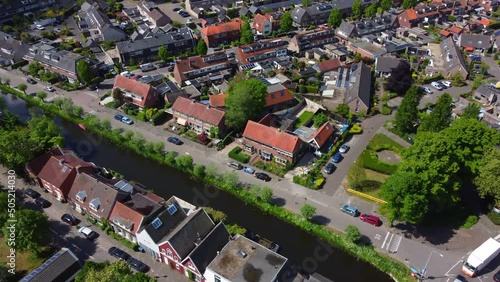 Kortenhoef neighbourhood village aerial view, North Holland municipality on the edge of rural countryside tilt down shot photo