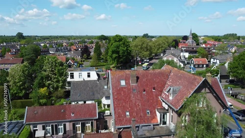 Gorgeous countryside red rooftop farmhouse aerial view rising reveal Kortenhoef rural Dutch scenic village photo