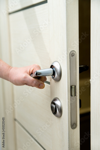 woman opening door. chrome door handle close-up.