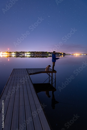 Fishing With Dog On Dock Reflection