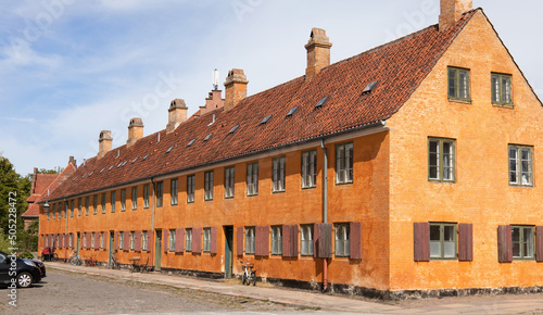 Beautiful view of old yellow houses in famous Nyboder districk with a bikes. High quality photo photo