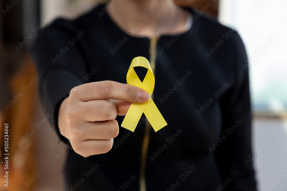 woman holding yellow ribbon. traffic accident prevention campaign or campaign against suicide. - obrazy, fototapety, plakaty 