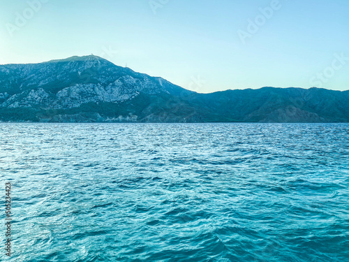 Coast. beauty of the sea, holidays in hot countries. next to the sea are high mountains in greenery and shrubs. blue waves of the sea