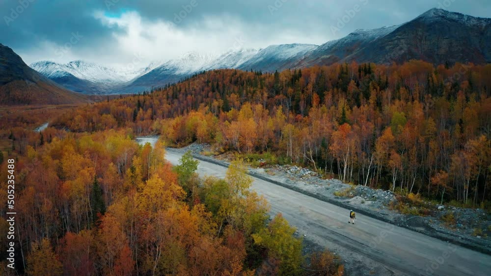 Aerial view of the Khibiny Mountains in Kola Peninsula in Russia with solo hiker walking on the road Aerial view of the Khibiny Mountains in Kola Peninsula in Russia with solo hiker walking on the road