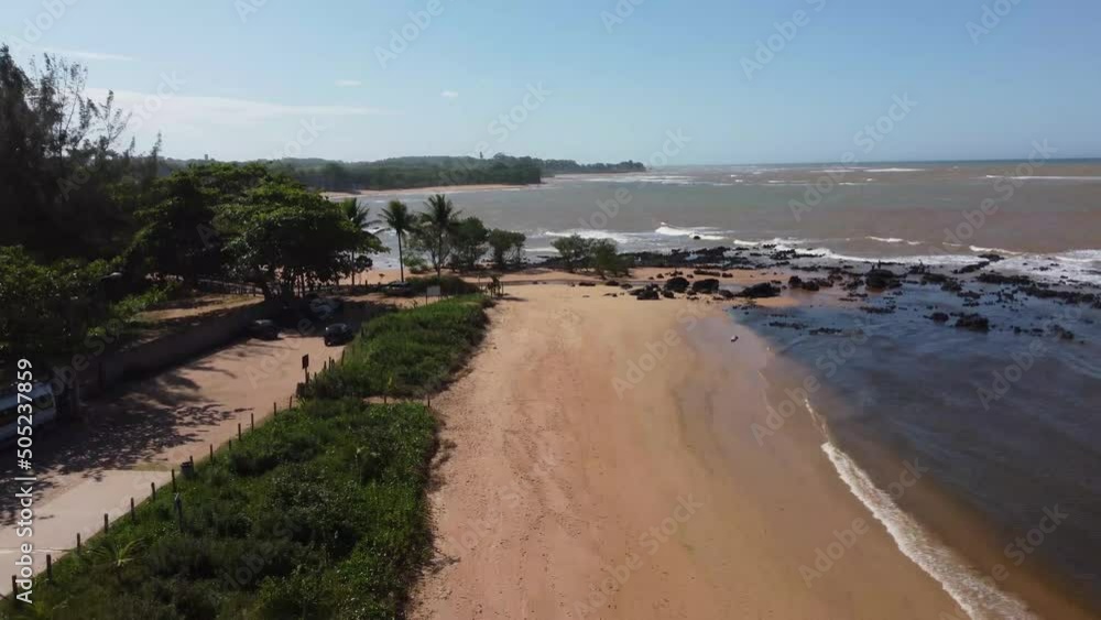 Beautiful beach with dark sands and black rocks like a volcano. Manguinhos, Espirito Santo, Brazil - aerial drone view Beautiful beach with dark sands and black rocks like a volcano. Manguinhos, Espirito Santo, Brazil - aerial drone view