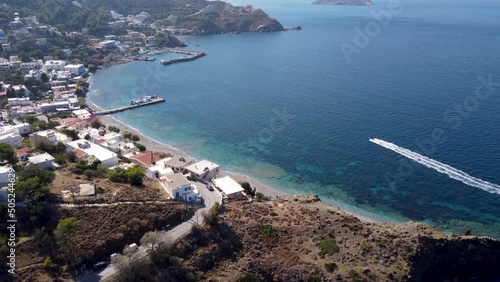 Aerial footage of a speed boat coming to Mirties village marina on sunny day. Kalymnos island, Greece. photo