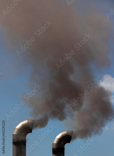Smoke coming out of two chimneys