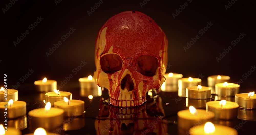 Blood stained skull against dark background closeup Blood stained skull against dark background closeup