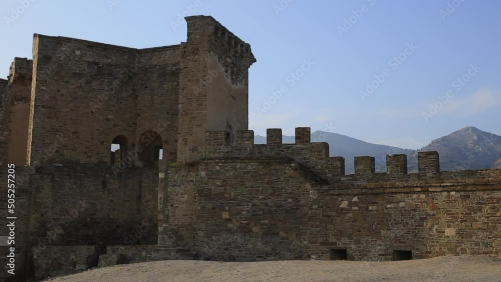 Courtyard of ancient Genoese fortress in Sudak town. Historic architectural landmark at sunny day. Crimea. Courtyard of ancient Genoese fortress in Sudak town. Historic architectural landmark at sunny day. Crimea.