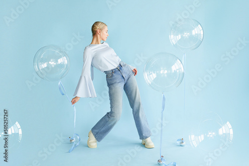 young blonde woman posing in studio with transparent balloons. Concept dreaming © Ксения Левашова