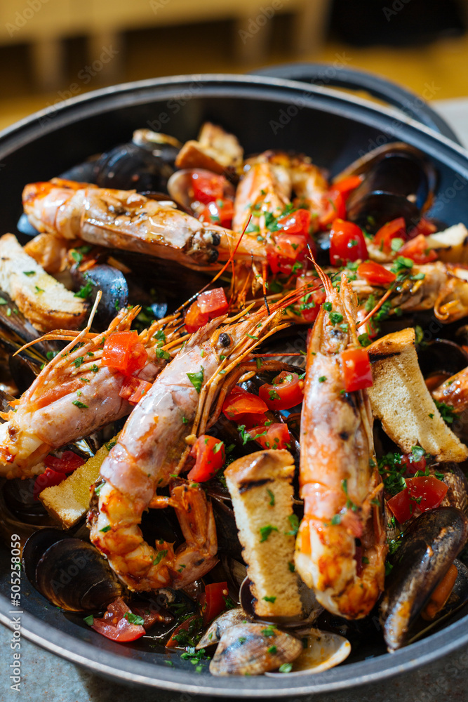 Venetian restaurant cooking scampi or Norway lobster Venetian restaurant cooking scampi or Norway lobster