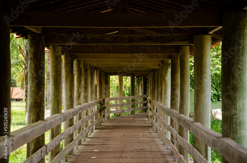 Wooden structure  with bridge  that passes over a lake. 