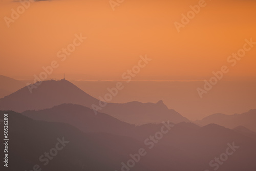 Beautiful evening view from the Schafberg mountain in upper austria  sunset colors fading into purple and violet throught the mountains.