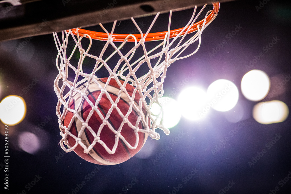 basketball game ball going through hoop