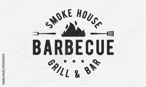 Barbecue Grill - vintage logo concept. Logo of Barbecue, Grill, Smoke House with fire flame, grill fork and spatula. BBQ logo, poster, stamp template. Vector illustration