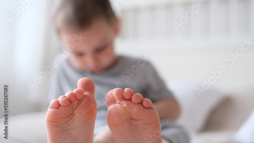 Close-up of childrens legs with feet forward