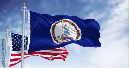 Fototapeta The Virginia state flag waving along with the national flag of the United States