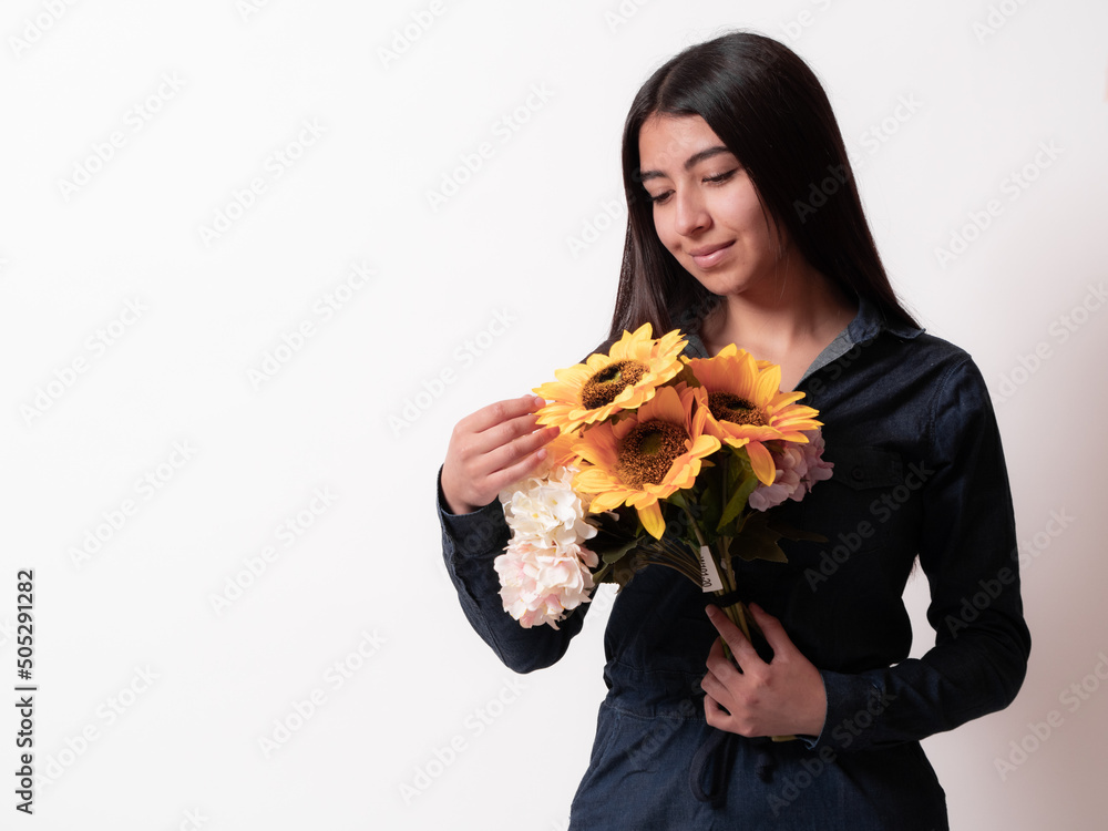 close up Hispanic woman isolated on white background holding in her hands a bouquet of sunflowers looking tenderly, gift concept for a woman, mother's day close up Hispanic woman isolated on white background holding in her hands a bouquet of sunflowers looking tenderly, gift concept for a woman, mother's day