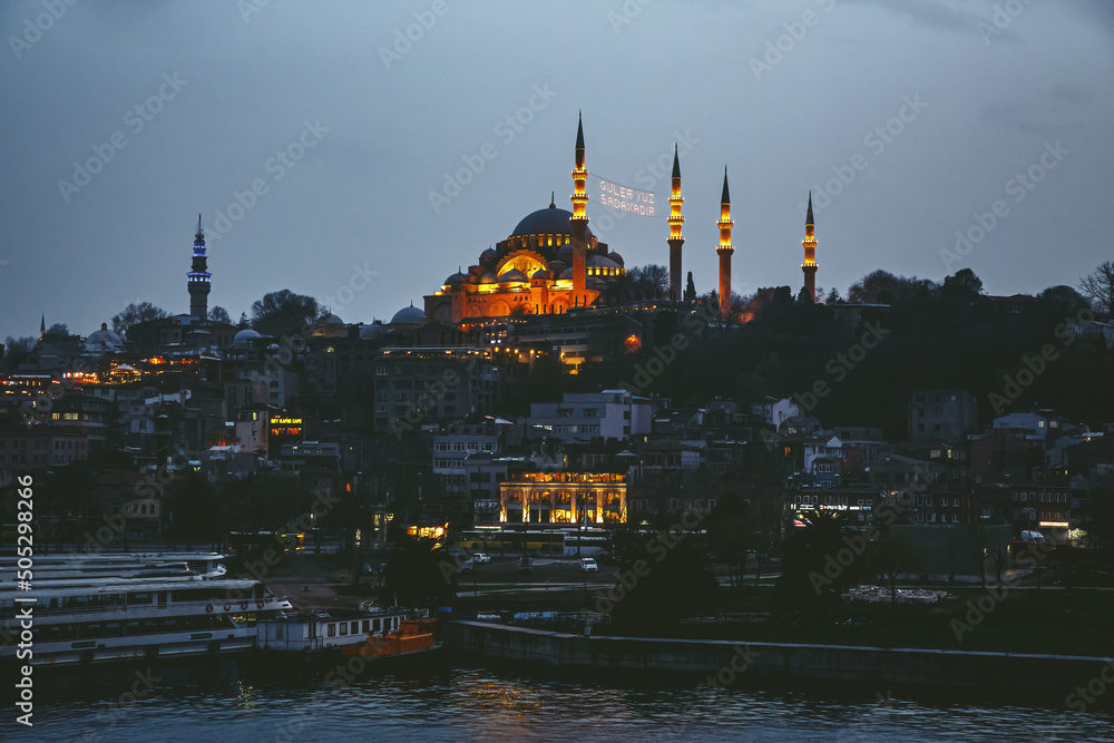 Suleymaniye Mosque with lights in the evening in the Istanbul skyline. Turkish city at night.