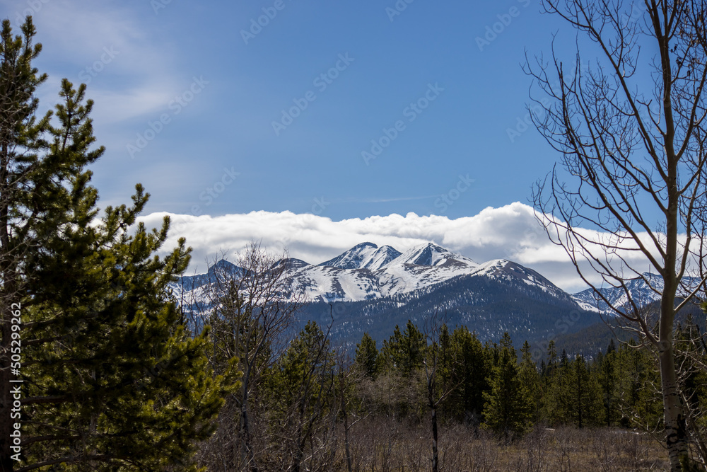 mountains called the crags are visible from a hiking trail in the Colorado Rocky Mountains at State Forest State Park
