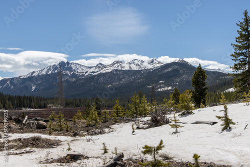 The Rocky Mountains are visible over a forested valley in State Forest State Park in Colorado