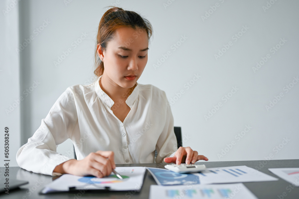 Female financial manager reviewing a business financial investment turnover report. Female financial manager reviewing a business financial investment turnover report.