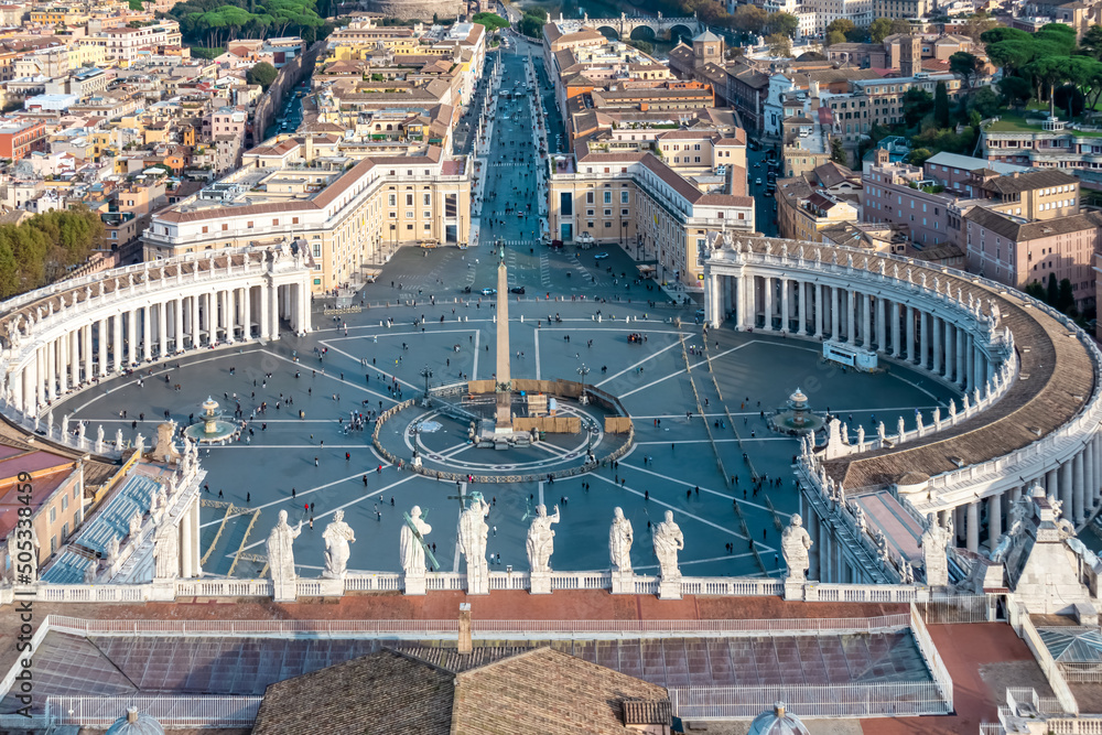 Panoramic scenic high angle aerial view on St Peters Square from top of Peters Basilica in Vatican City, Rome, Lazio, Europe, EU. Catholic statues overlooking Piazza with Egyptian obelisk in center