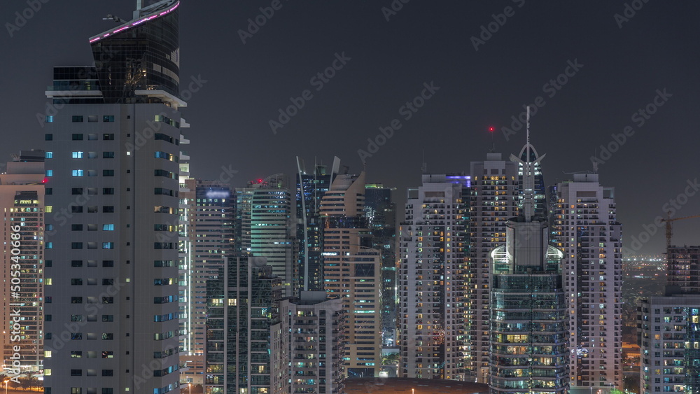 Dubai Marina Skyline with JLT district skyscrapers on a background aerial night timelapse. Dubai Marina Skyline with JLT district skyscrapers on a background aerial night timelapse.
