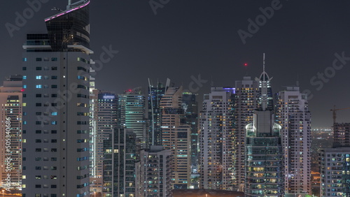 Dubai Marina Skyline with JLT district skyscrapers on a background aerial night timelapse.