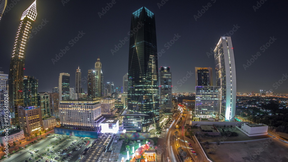 Panorama of Dubai International Financial district night timelapse. Aerial view of business and financial office towers.