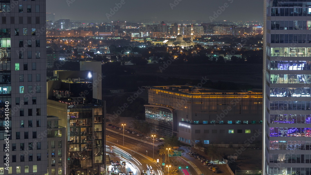 Skyline view of traffic on Al Saada street near DIFC district night timelapse in Dubai, UAE.
