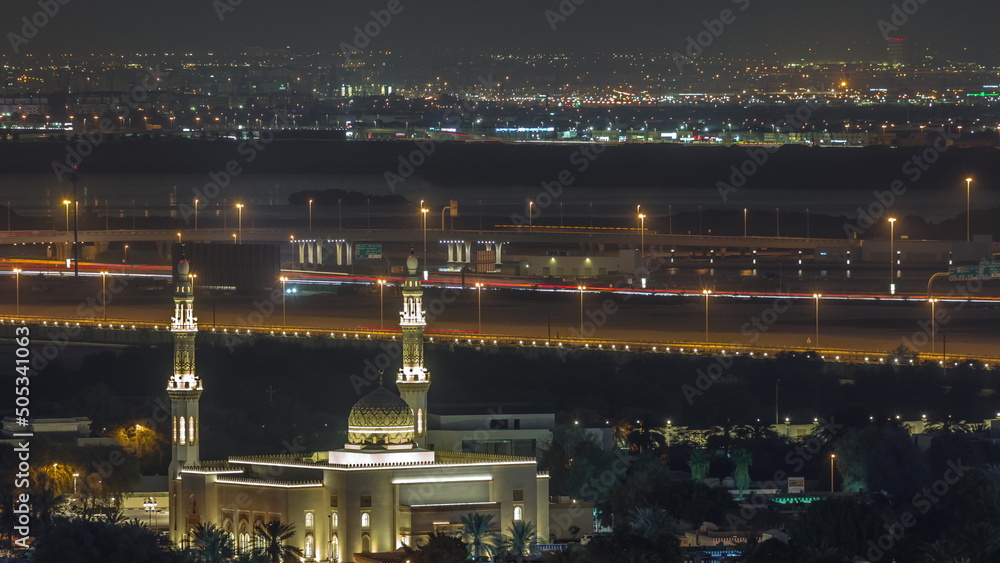 Aerial view of mosque and neighbourhood Deira on a background night timelapse. Dubai, United Arab Emirates