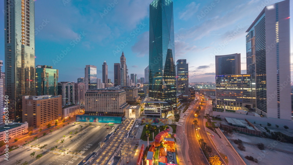 Fototapeta premium Dubai International Financial district aerial night to day timelapse. Panoramic view of business office towers.