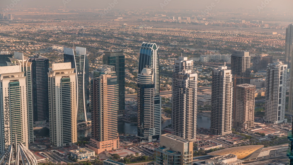 Fototapeta premium Jumeirah Lakes Towers district with many skyscrapers along Sheikh Zayed Road aerial timelapse.