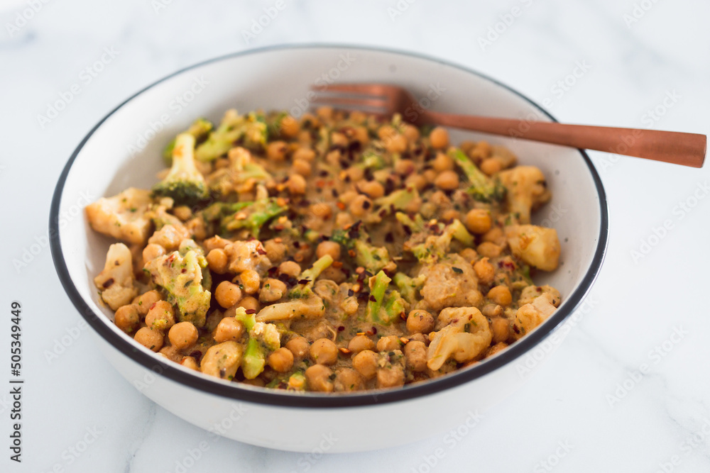healthy plant-based food, vegan spicy chickpeas broccoli and cauliflower stir-fry with peanut sauce healthy plant-based food, vegan spicy chickpeas broccoli and cauliflower stir-fry with peanut sauce