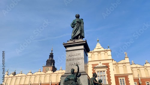 Beautiful closeup view on Adam Mickewicz Monumant and blue sunny sky in sunny day in Krakow, Poland photo