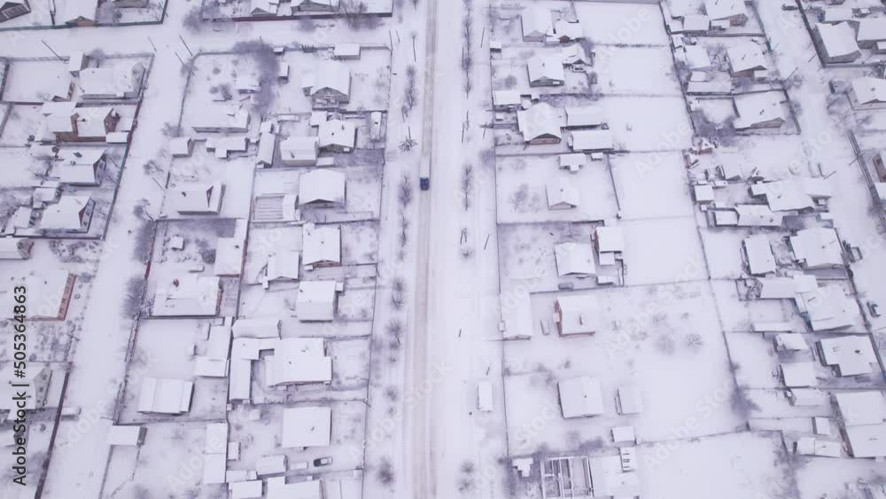 Aerial view of the ukrainian snow village with private houses and garden plots at winter time. Shooting from a drone. Ukraine, Eastern Europe Aerial view of the ukrainian snow village with private houses and garden plots at winter time. Shooting from a drone. Ukraine, Eastern Europe