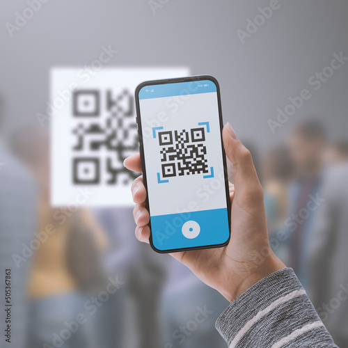 Woman scanning a QR code using her smartphone