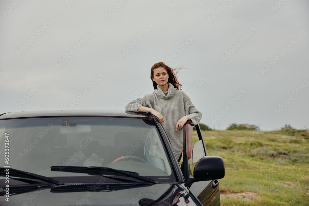 Naklejka premium woman near car travel nature trip female relaxing