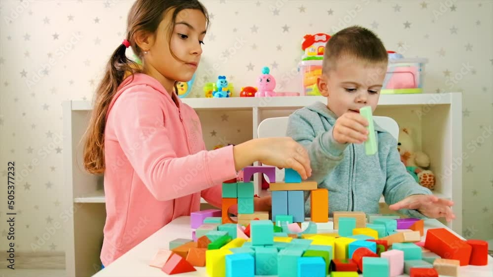 The child plays with toys in the room. Selective focus. The child plays with toys in the room. Selective focus.