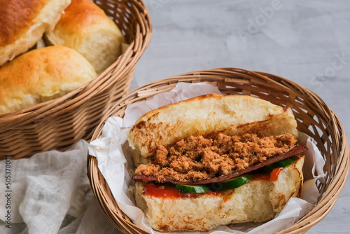 Homemade popular street food meal. Jerky Sandwich Bun with Meat Floss. Choice of chili sauce or ketchup sauce with cucumber slices. photo