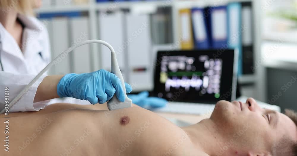 Doctor cardiologist conducting ultrasound examination of heart of young man 4k movie Doctor cardiologist conducting ultrasound examination of heart of young man 4k movie