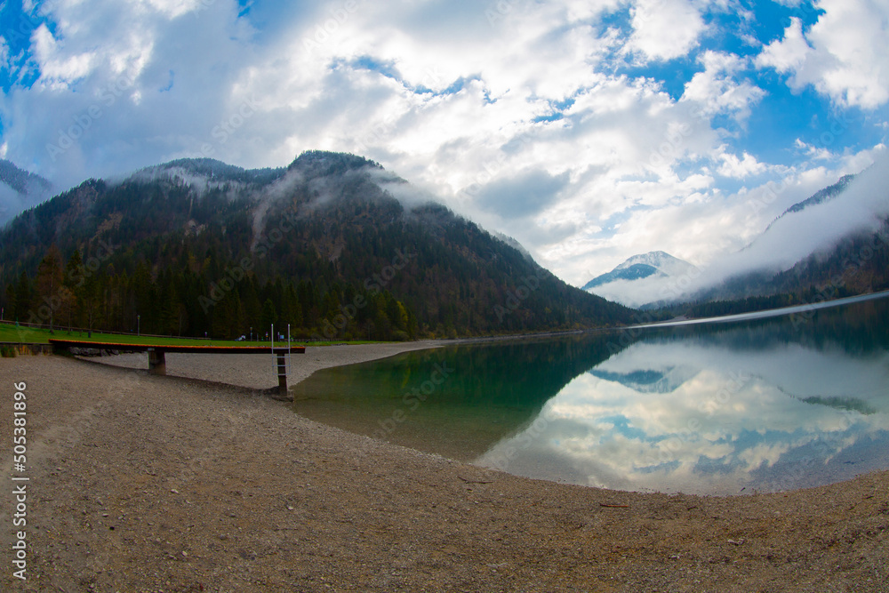 Beautiful austrian mountain lake plansee with reflection of the ...