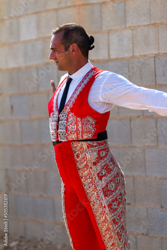 long shot of a bullfighter preparing and stretching his muscles before the bullfight