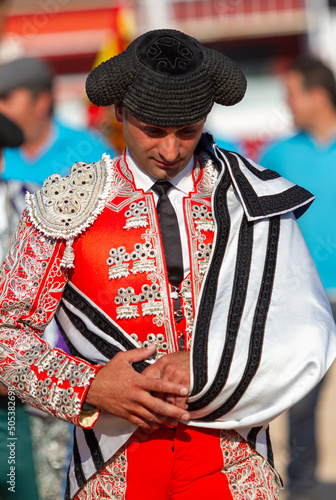 a bullfighter greets the president of the celebration at the beginning of a bullfight