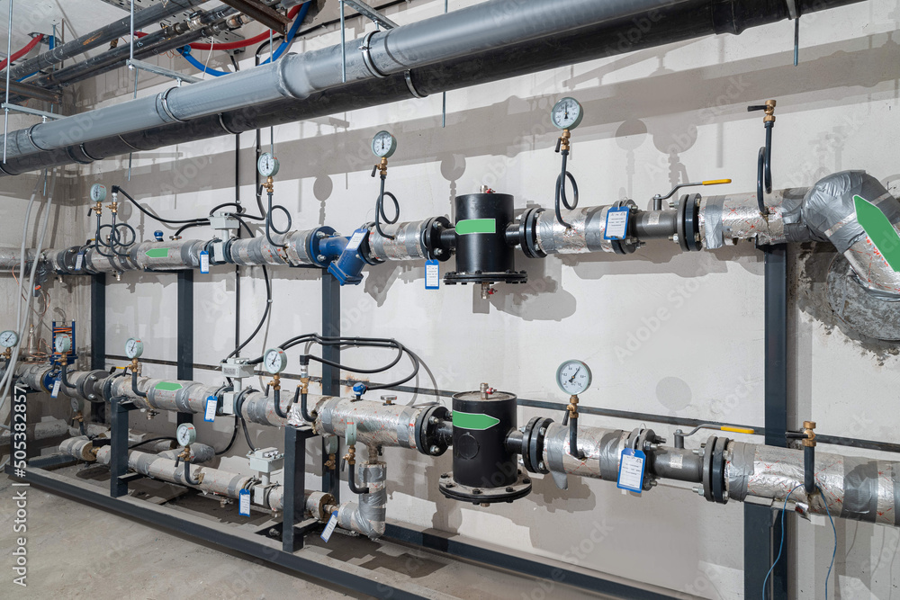 Modern industrial building with pipes, heat exchangers and valves Modern industrial building with pipes, heat exchangers and valves