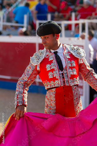 a Spanish bullfighter practices with his capote moments before the bullfight photo