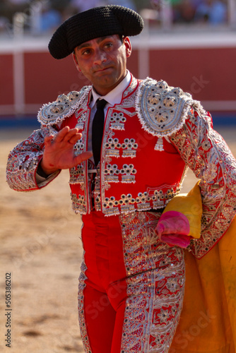 close up of a smiling bullfighter greets the public after the end of a bullfight photo
