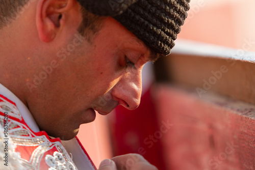 Close up of a bullfighter praying before the bullfight